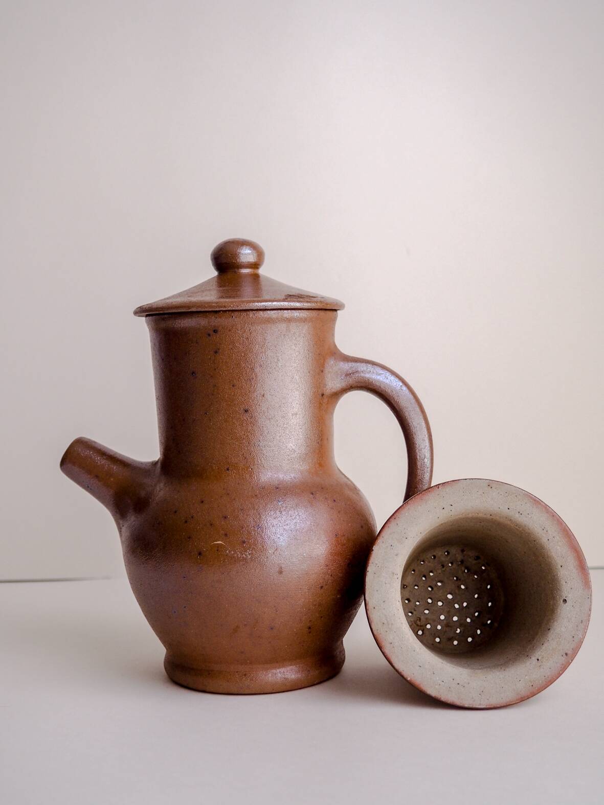 Handcrafted stoneware teapot with strainer