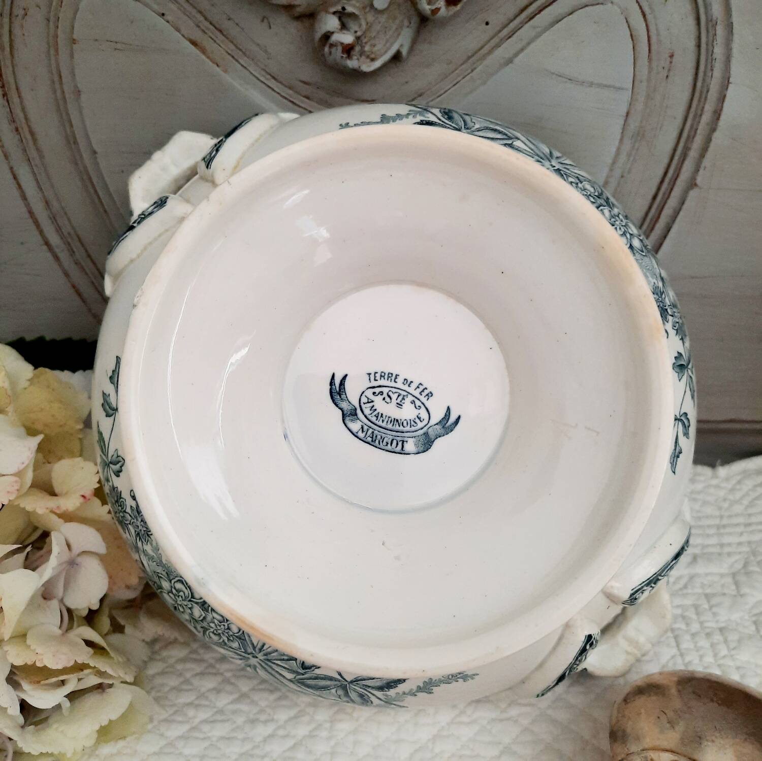Old mismatched hollow plates in iron earth earthenware accompanied by a soup tureen