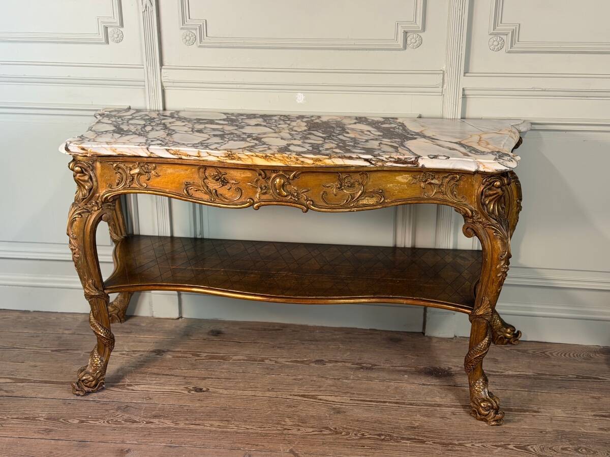 Golden wooden console, four legs adorned with sea monsters, purple breccia marble, around 1900.