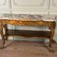 Golden wooden console, four legs adorned with sea monsters, purple breccia marble, around 1900.