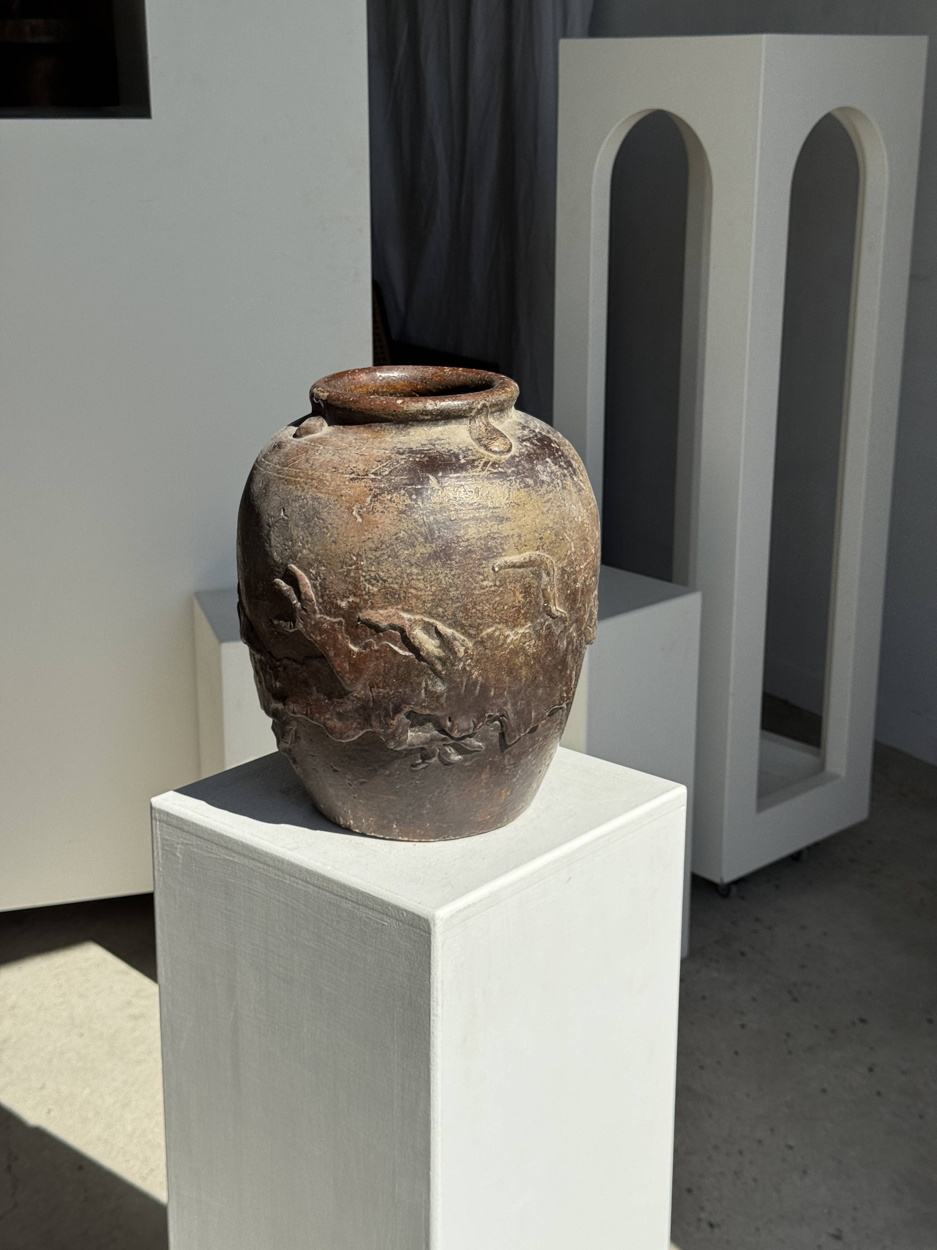 Large traditional Indonesian clay pot featuring a dragon.