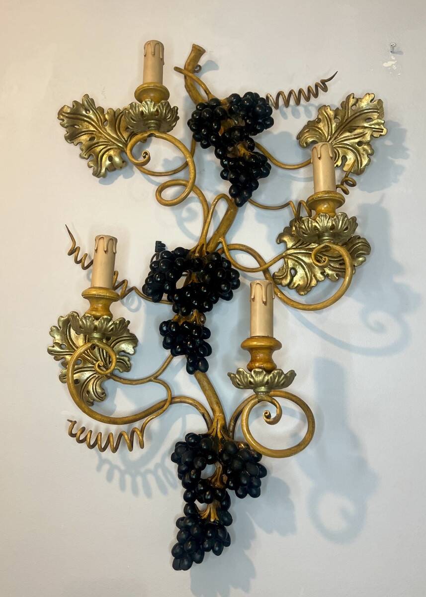 Large pair of wall sconces with vine decorations.