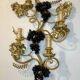 Large pair of wall sconces with vine decorations.