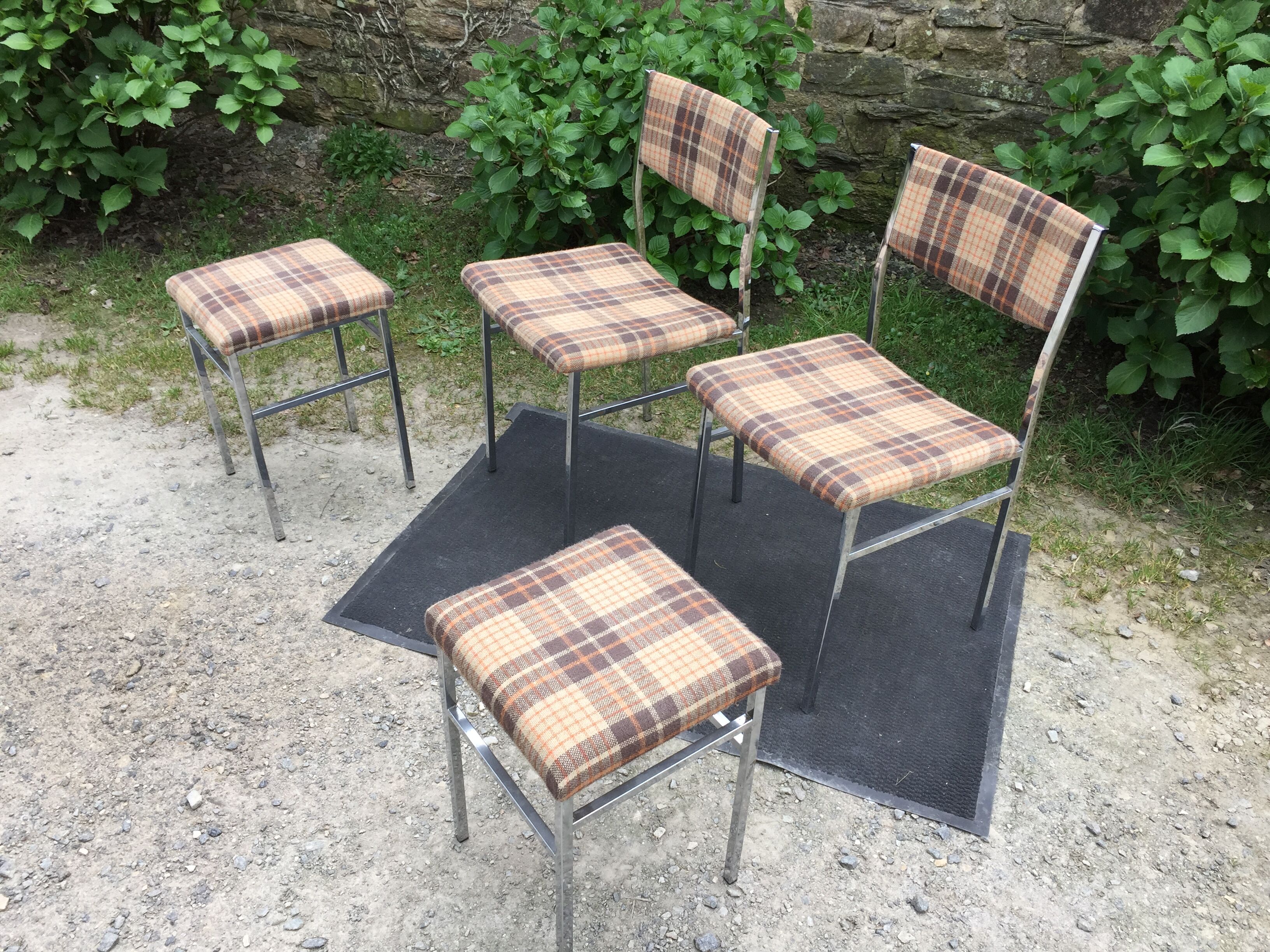 Vintage chairs and stools with chrome-plated square tubular metal base.