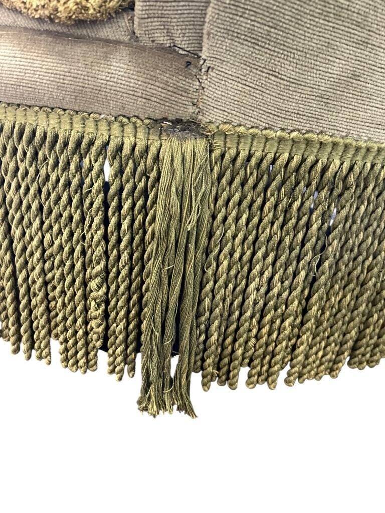 Vintage green two-seater sofa with fringes