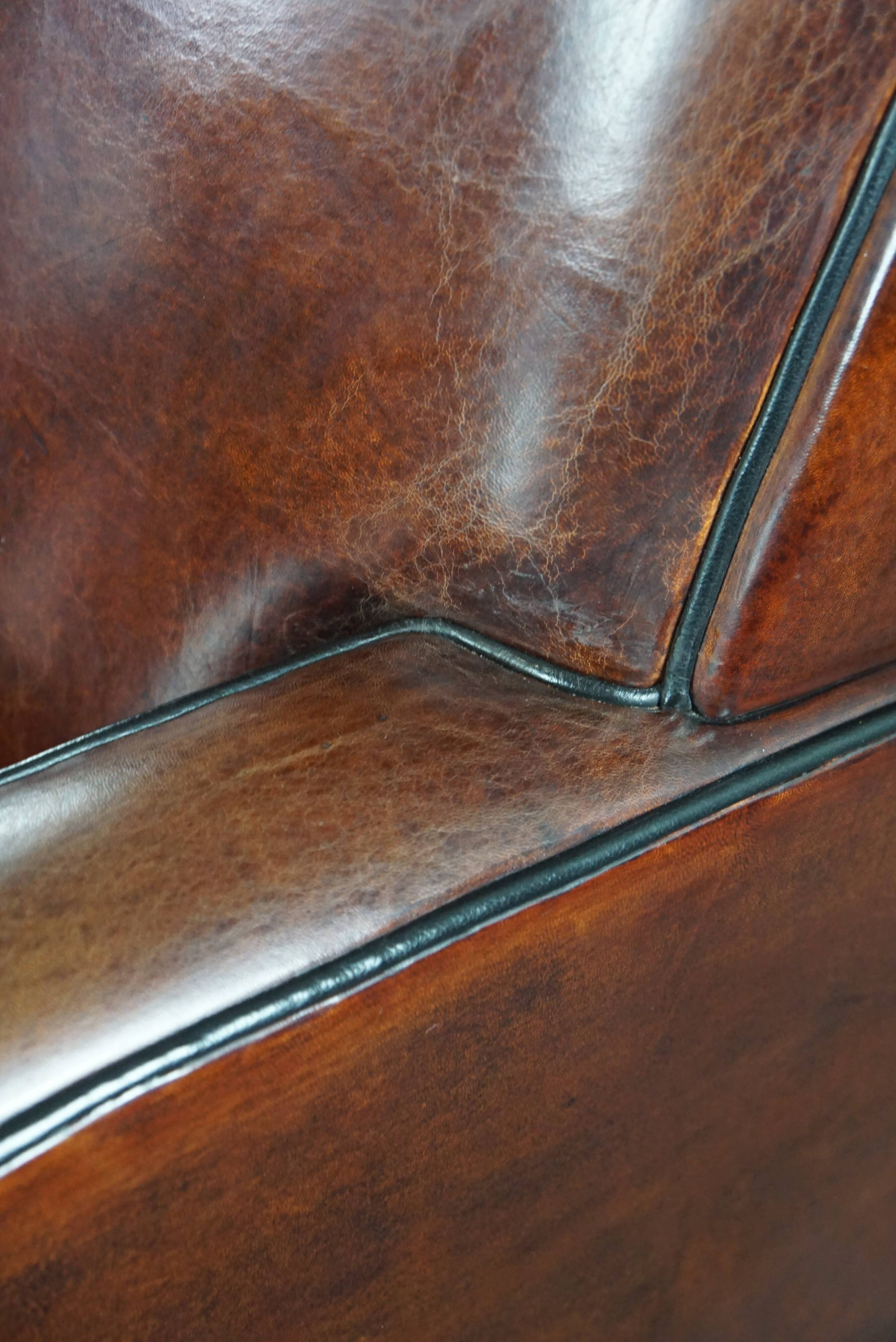 A very beautiful set of 2 Art Deco design armchairs in sheep leather