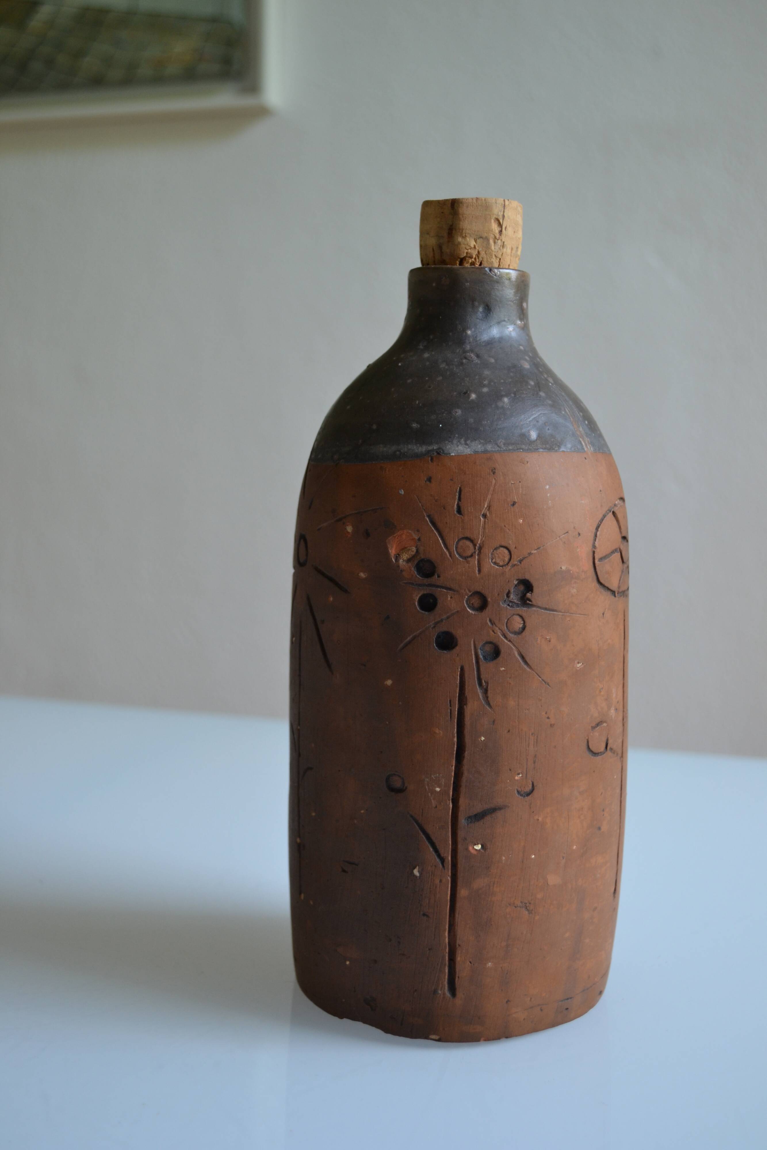 Bottle vase decorative flowers ceramic signature with fish to identify.