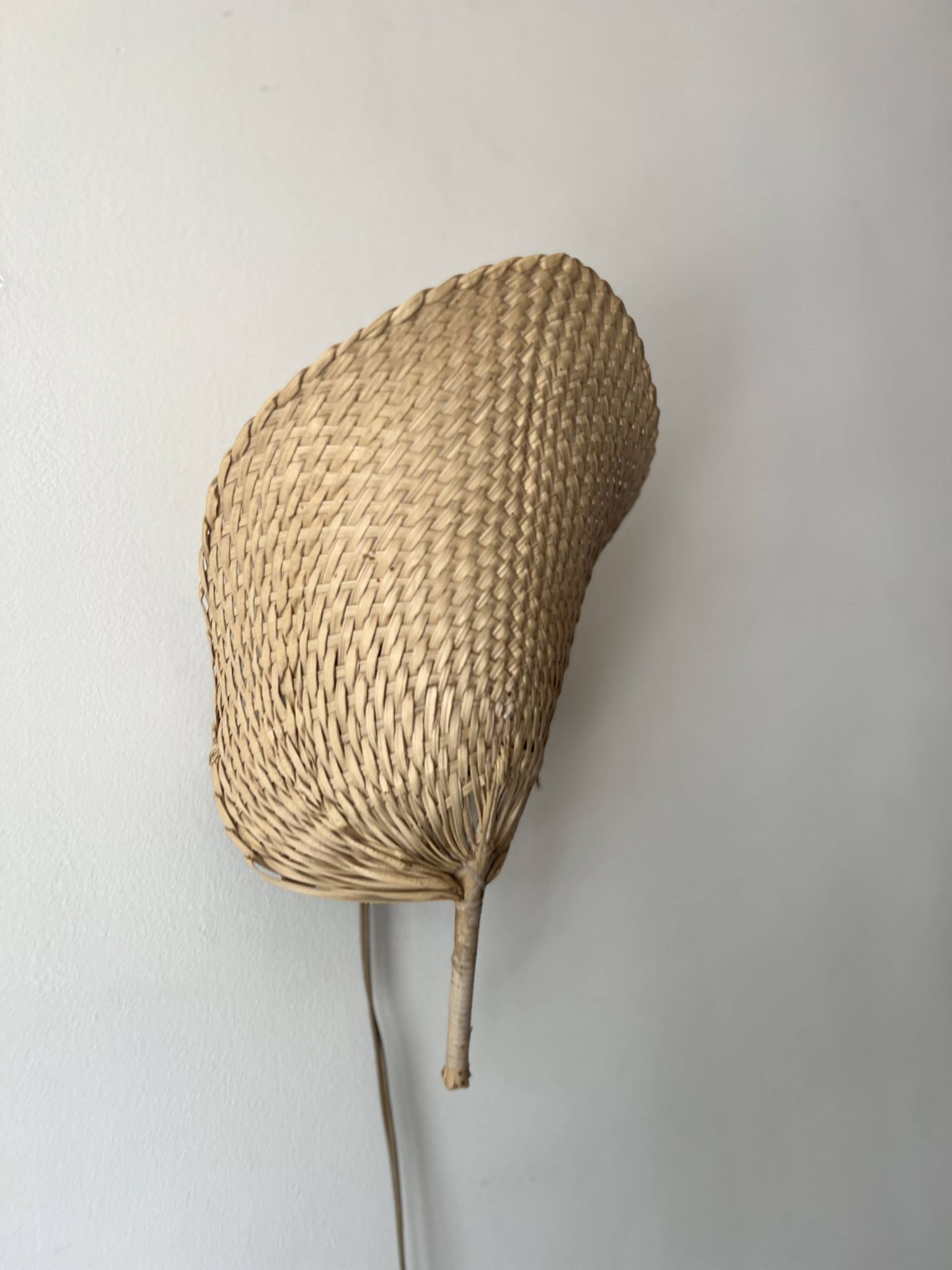 Woven rattan wall light in the style of Igno Maurer, design from the 1970s.