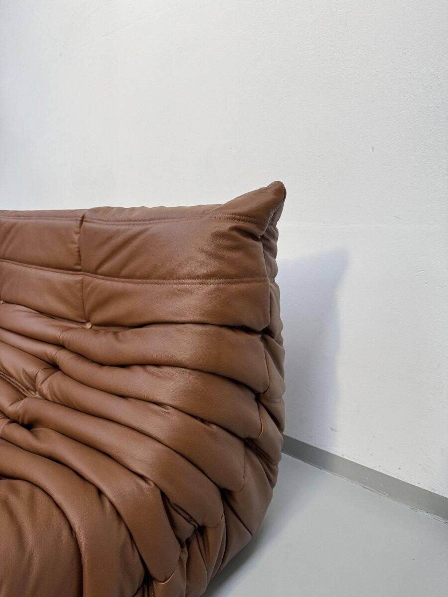 Three-seater Togo sofa in dark cognac leather by Michel Ducaroy for Ligne Roset.