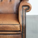 Large and comfortable sheepskin leather wingback chair with black piping