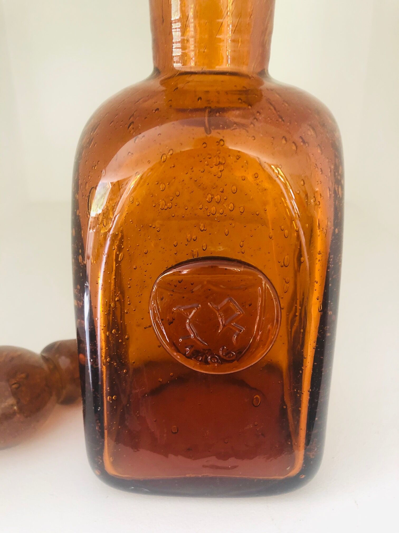 Old carafe in amber and bulled Biot glass, stamp 1496.