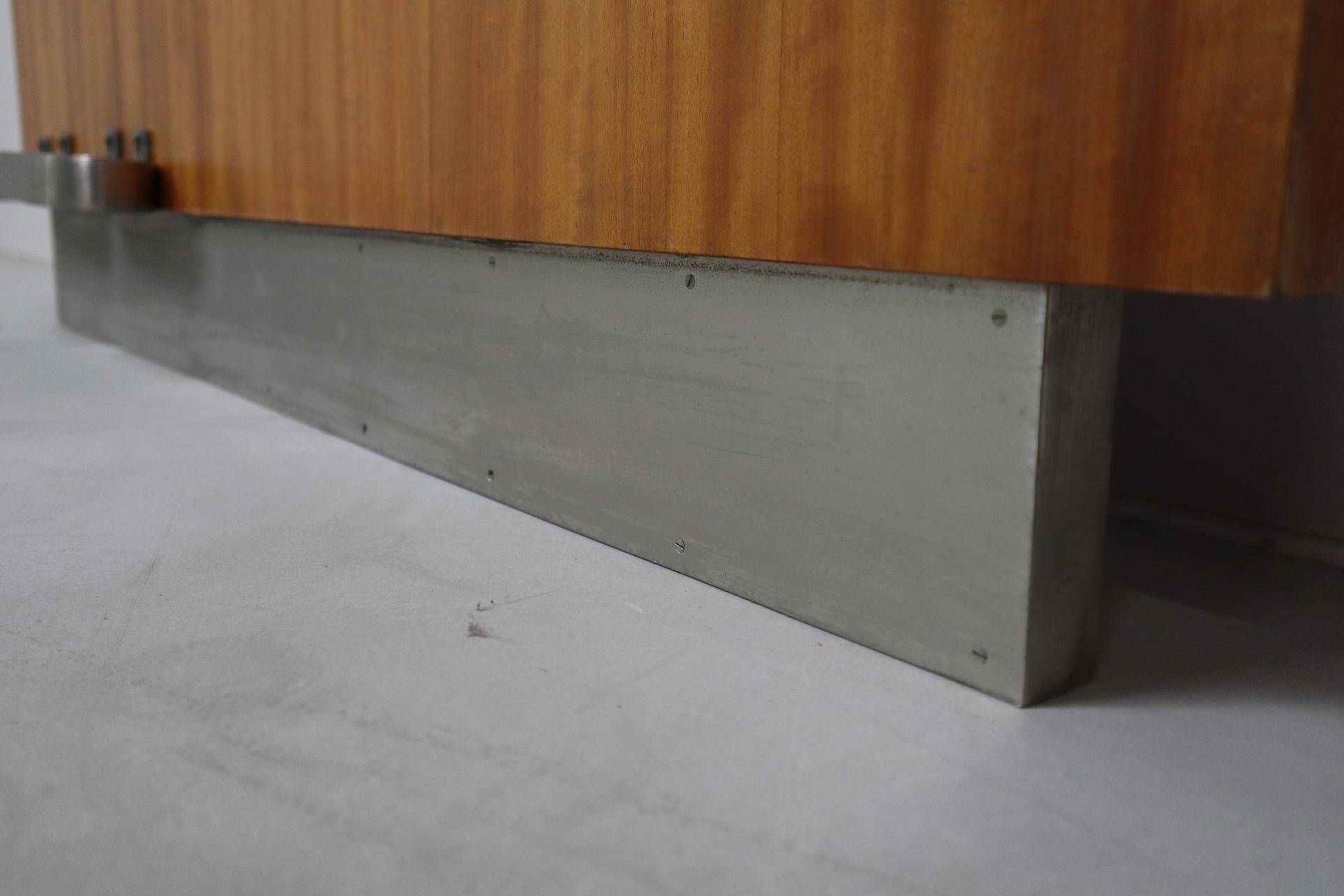 Modernist wall-mounted cloakroom in teak