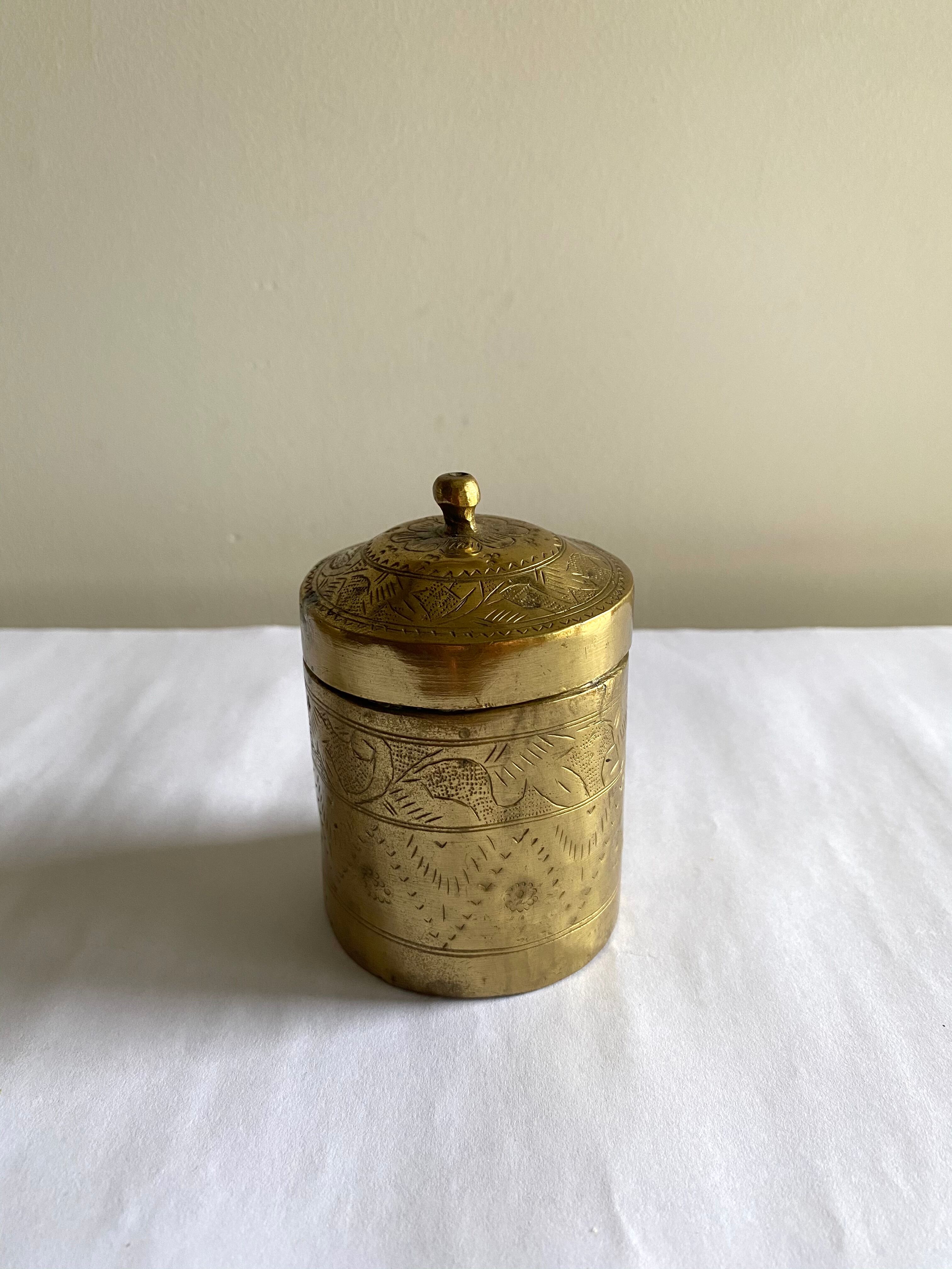 Old round box in chiseled brass