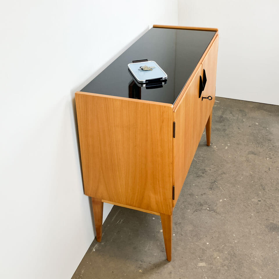 Small sideboard, WK Möbel, light coloured veneer with black glass top, 50s