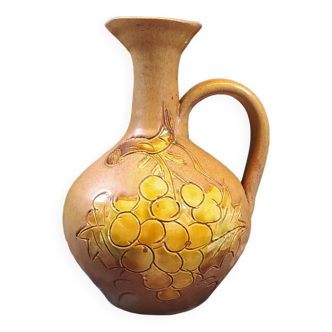 Vintage stoneware pitcher with grape motifs