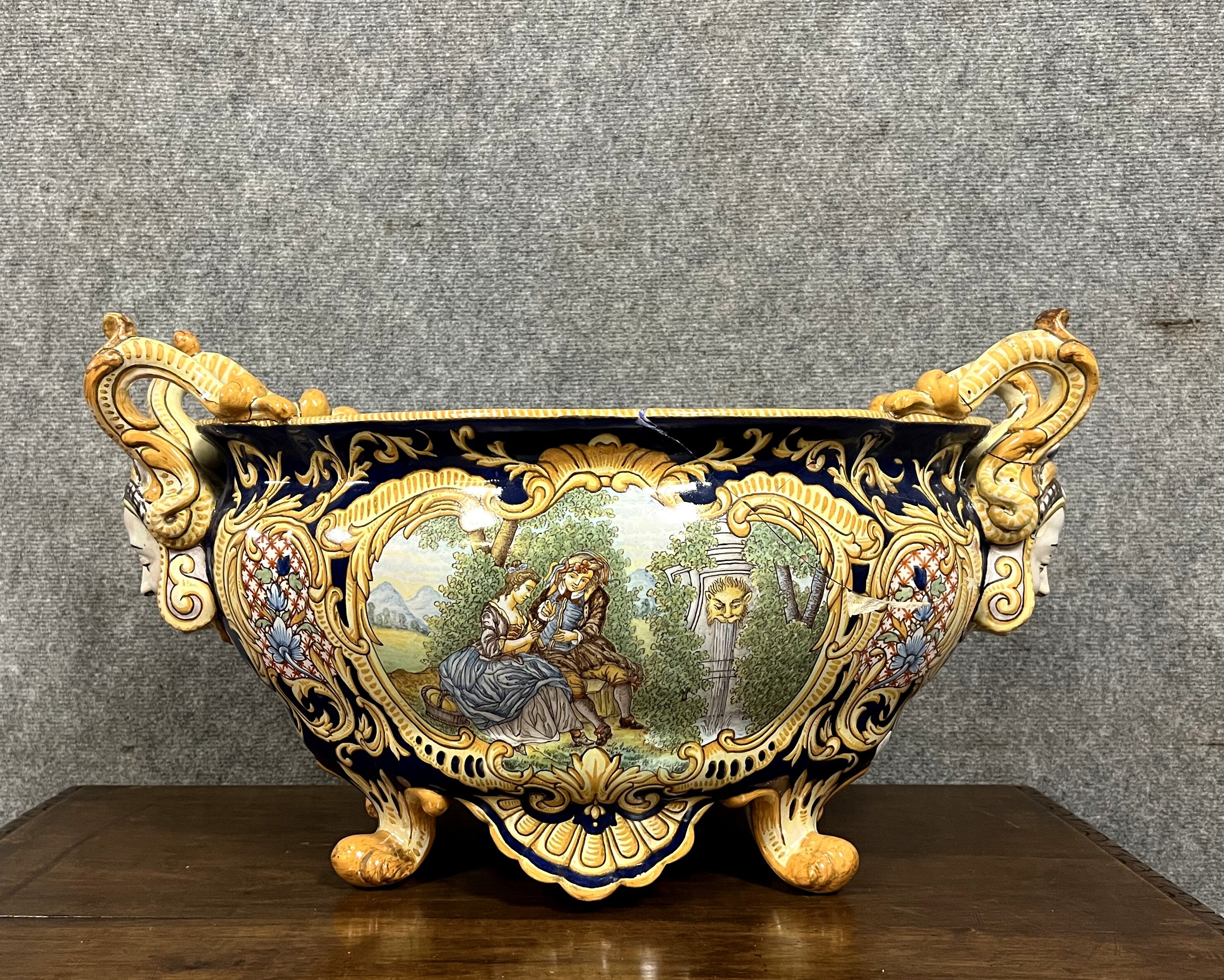 Earthenware planter with polychrome enamelled decoration on a blue background