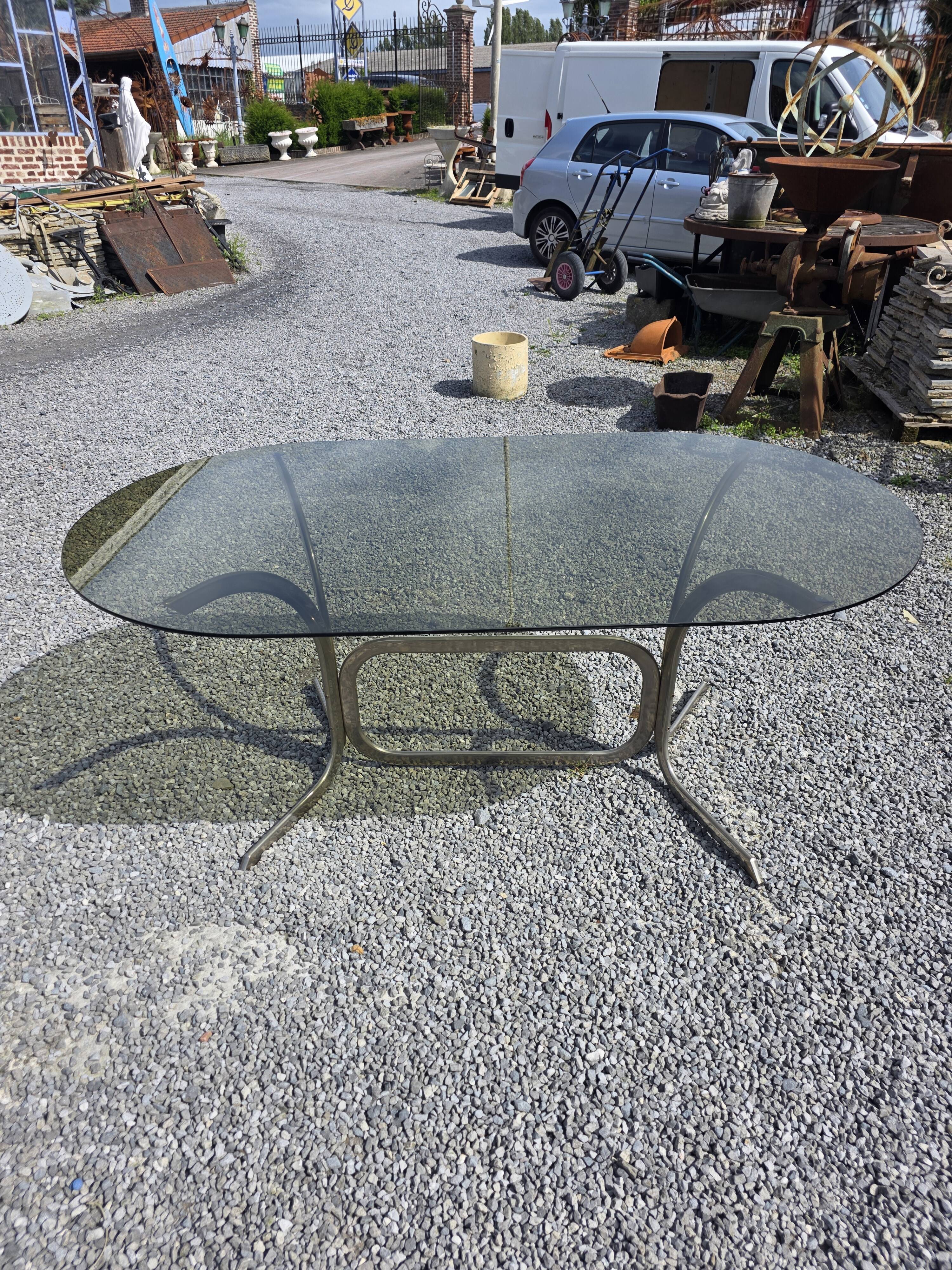 Silver metal table with smoked glass top from the 1970s.
