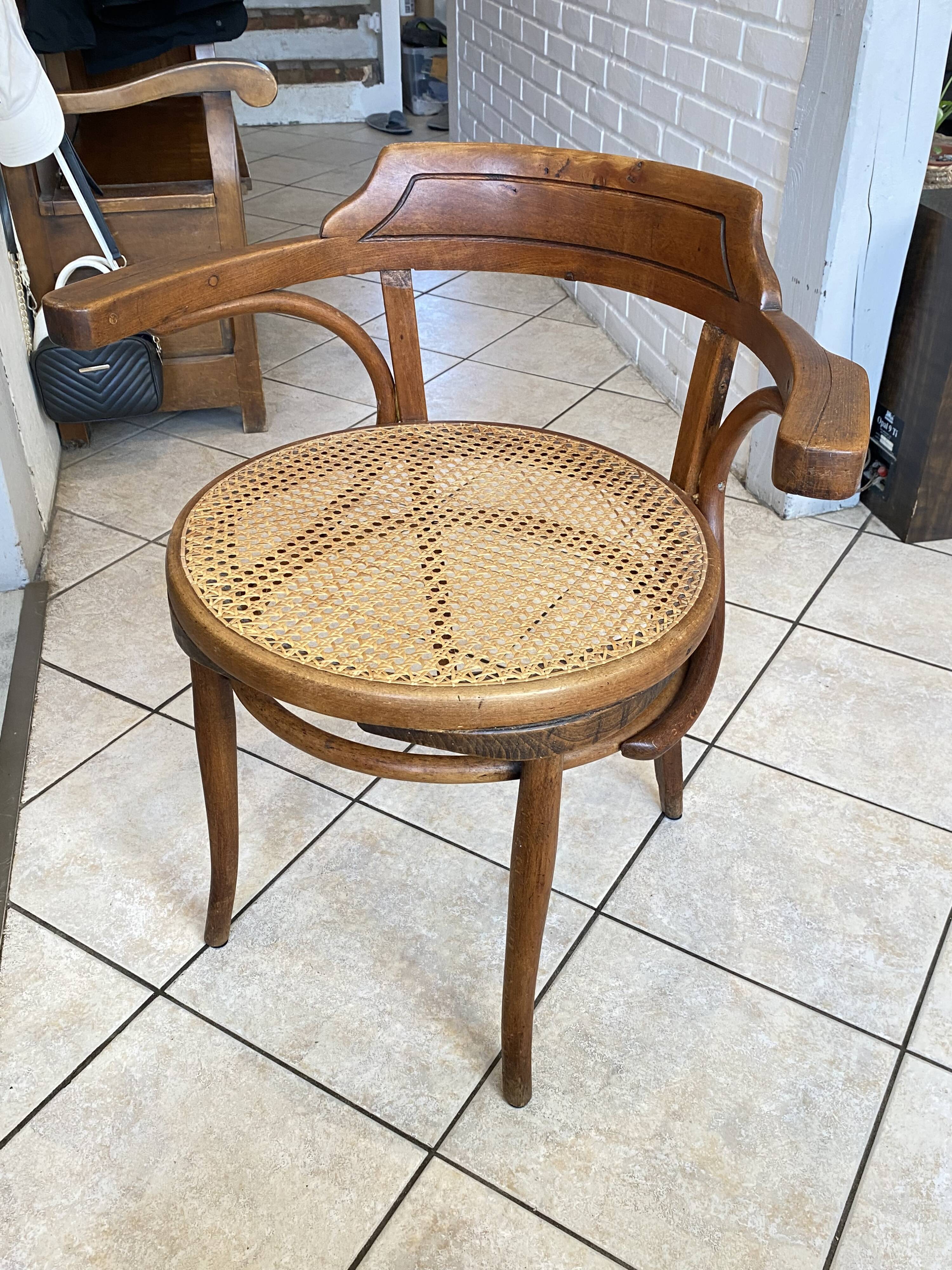 Bistro chair with a curved wooden frame and caned seat from the 1930s.
