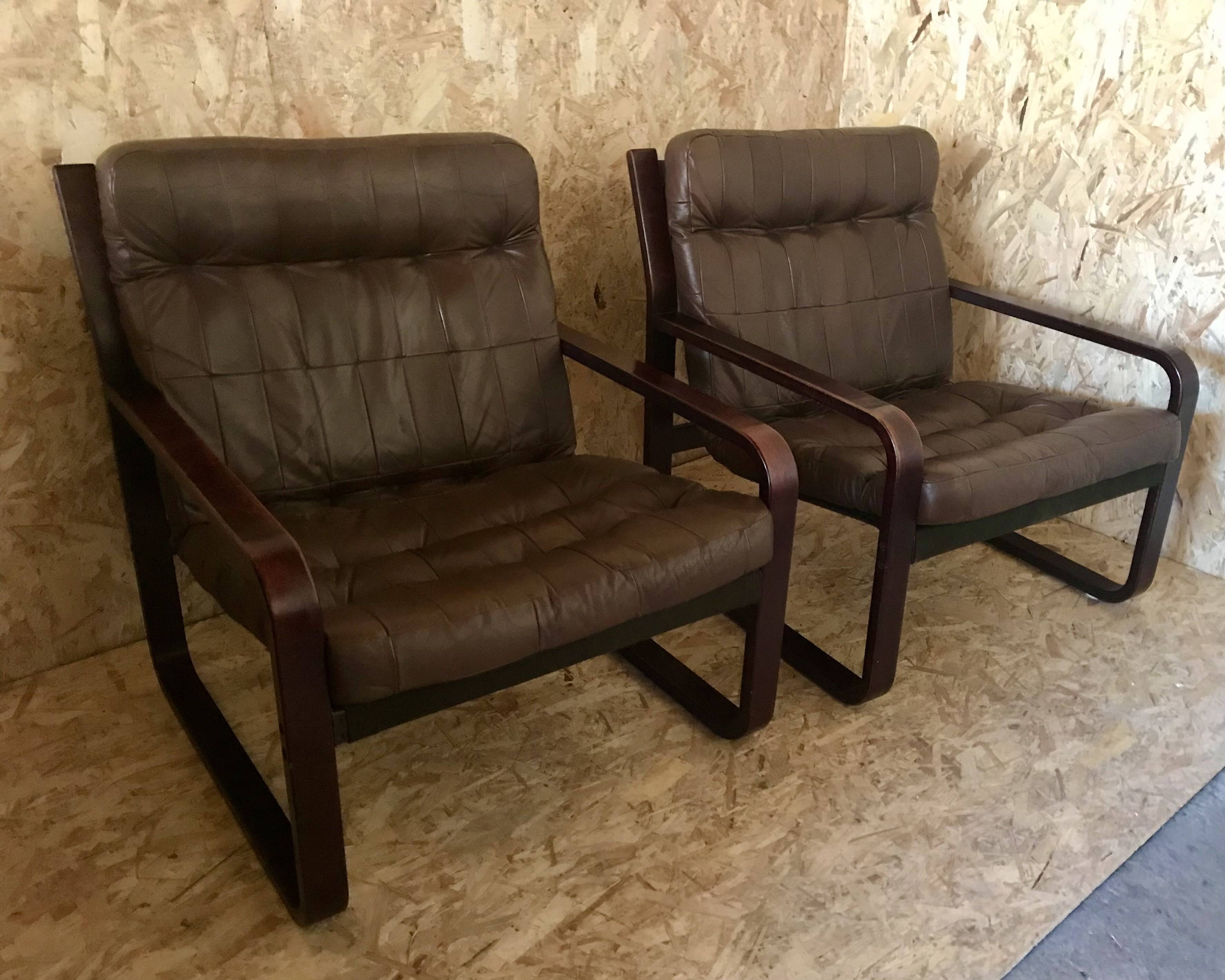 Pair of vintage armchairs in curved wood with suspended seat circa 1970-80.