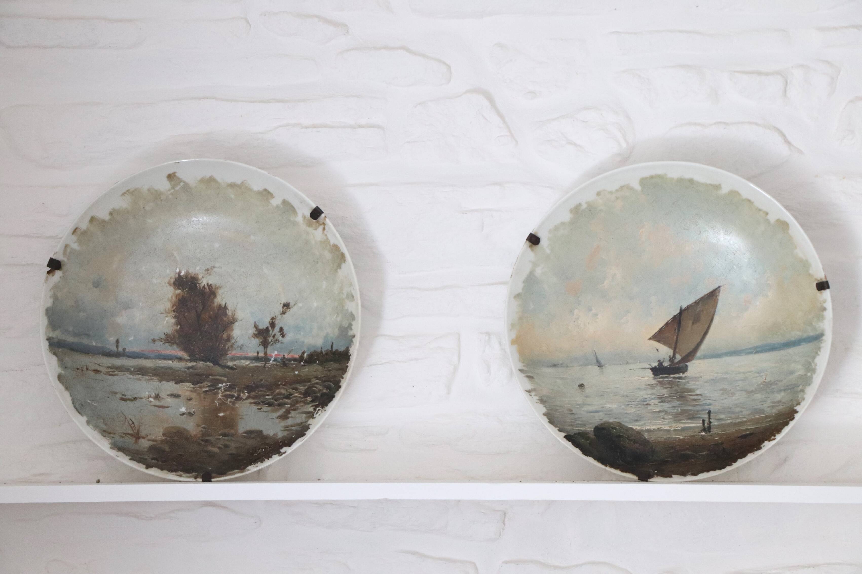 Pair of large hand-painted plates, sailing boat and landscape – late 19th century
