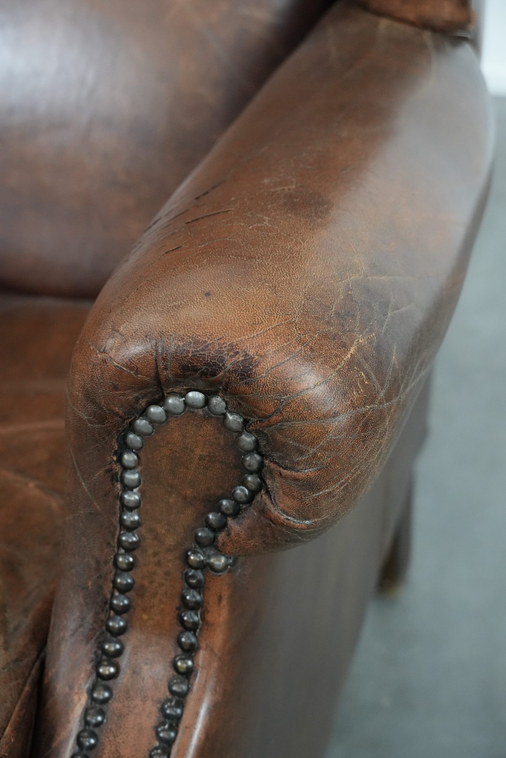 Vintage wingback armchair made of sheepskin leather with beautiful colours