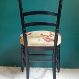 Black Napoleon III chair lined with phoenix