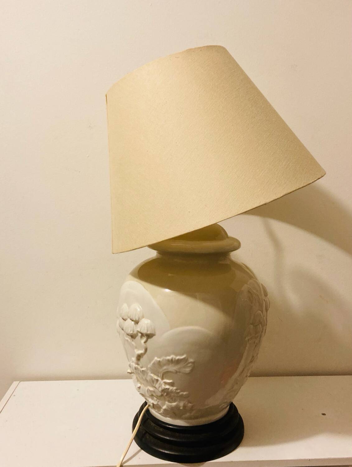 1980s ceramic table lamp with a wooden base and adjustable shade.