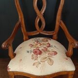 Upholsterer armchair covered with a publisher fabric with a central floral pattern