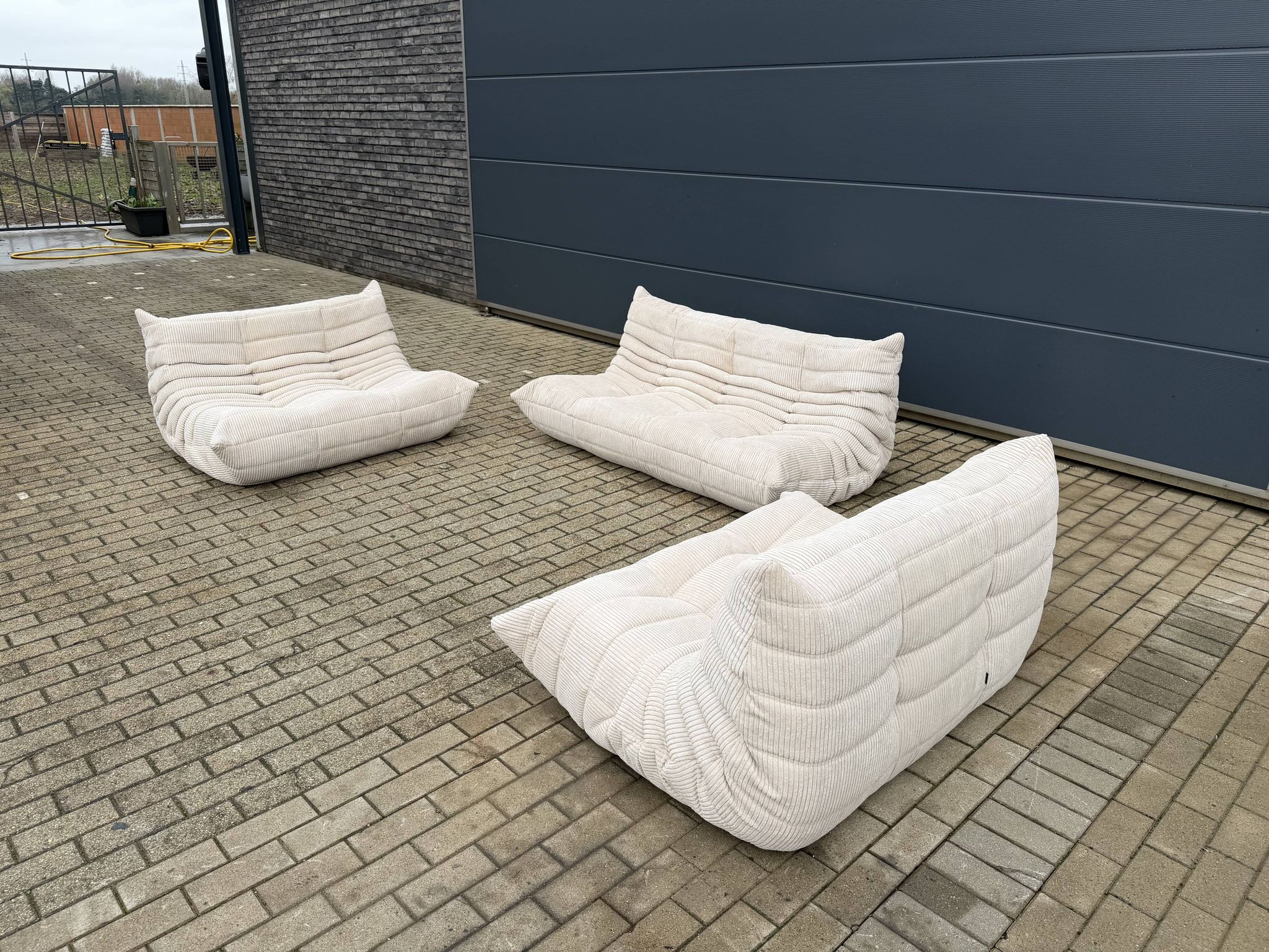 Ligne Roset Togo 3-seater and 2 x 2-seaters in beige corduroy.