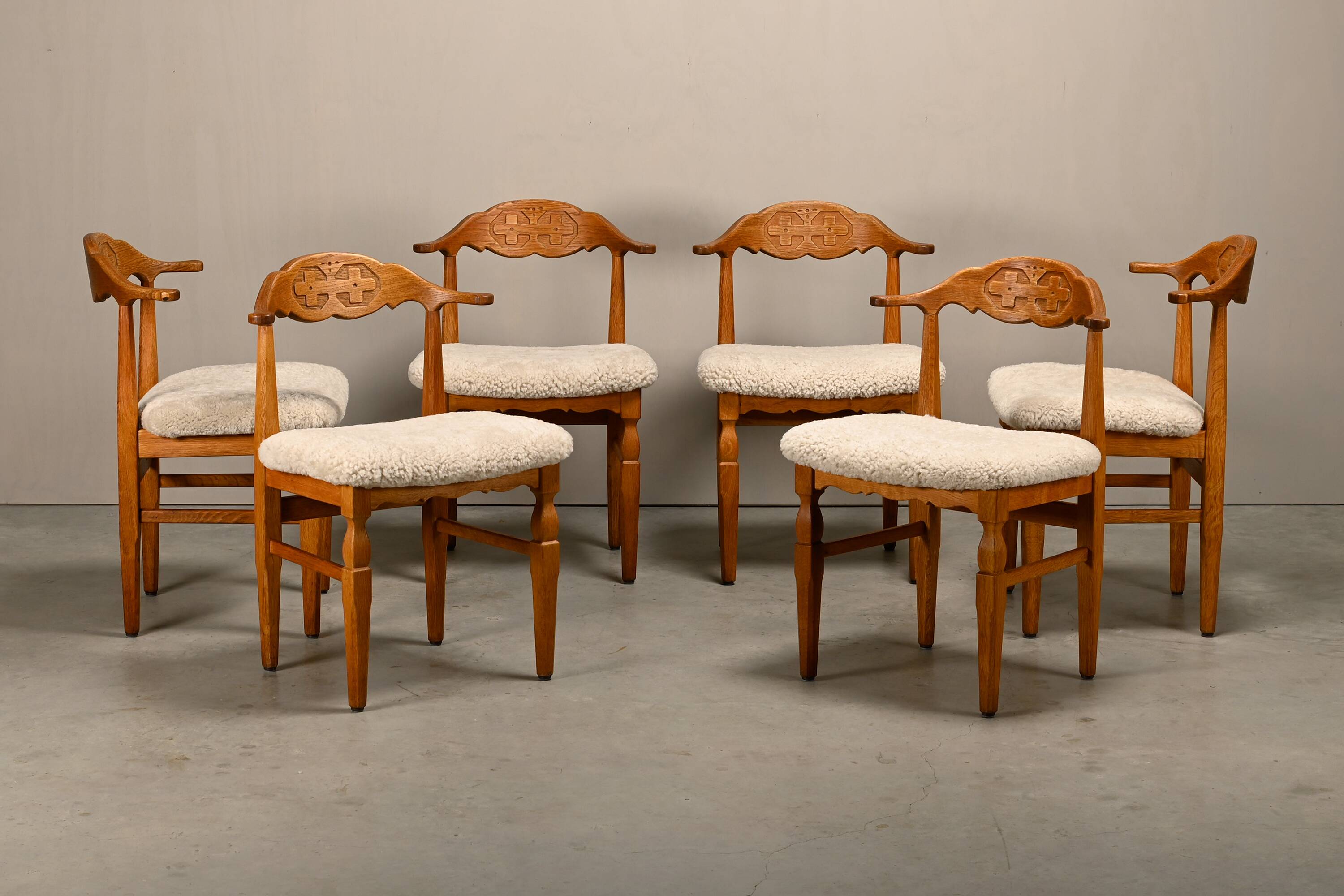 Henning Kjærnulf brutalist dining chairs set in Oak and Sheepskin, Denmark