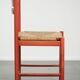 Nice red vintage wooden chair from the 1970s with a woven wicker seat