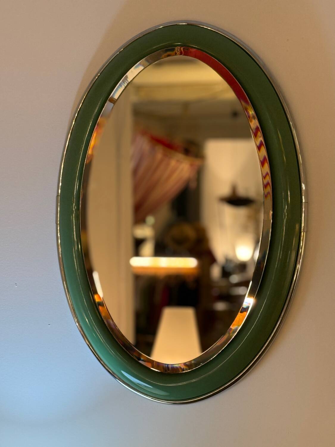 Vintage oval mirror with English green lacquered curved frame and chrome surround