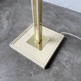 Floor lamp with articulated arm in brass-plated metal