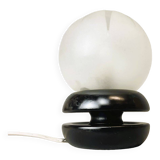 Small black wooden table lamp with frosted glass globe