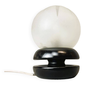 Small black wooden table lamp with frosted glass globe