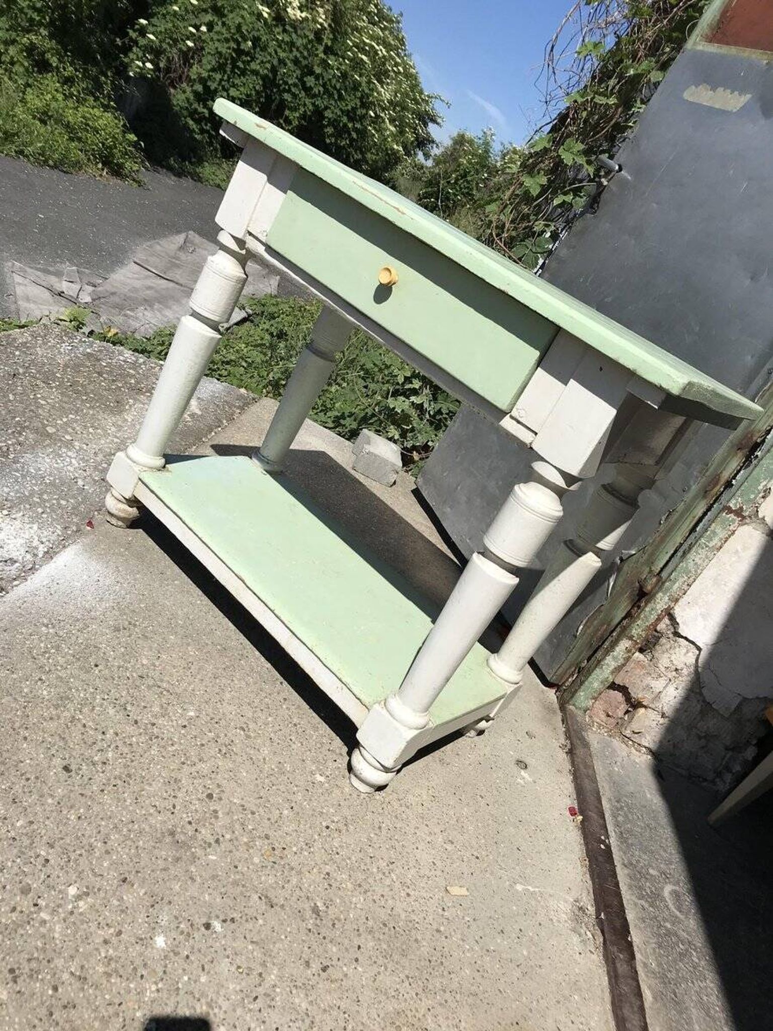 Rustic wooden dining table painted white and pale green, with a central drawer, 1950s.