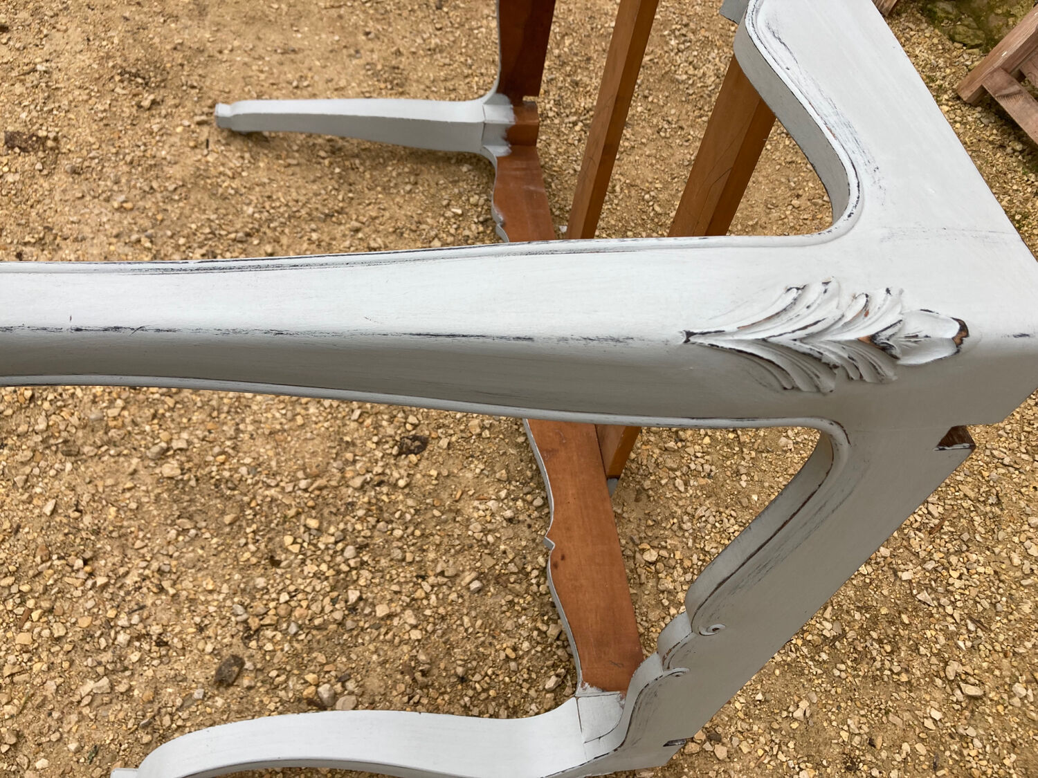 Louis XV style walnut table with a natural wood top.