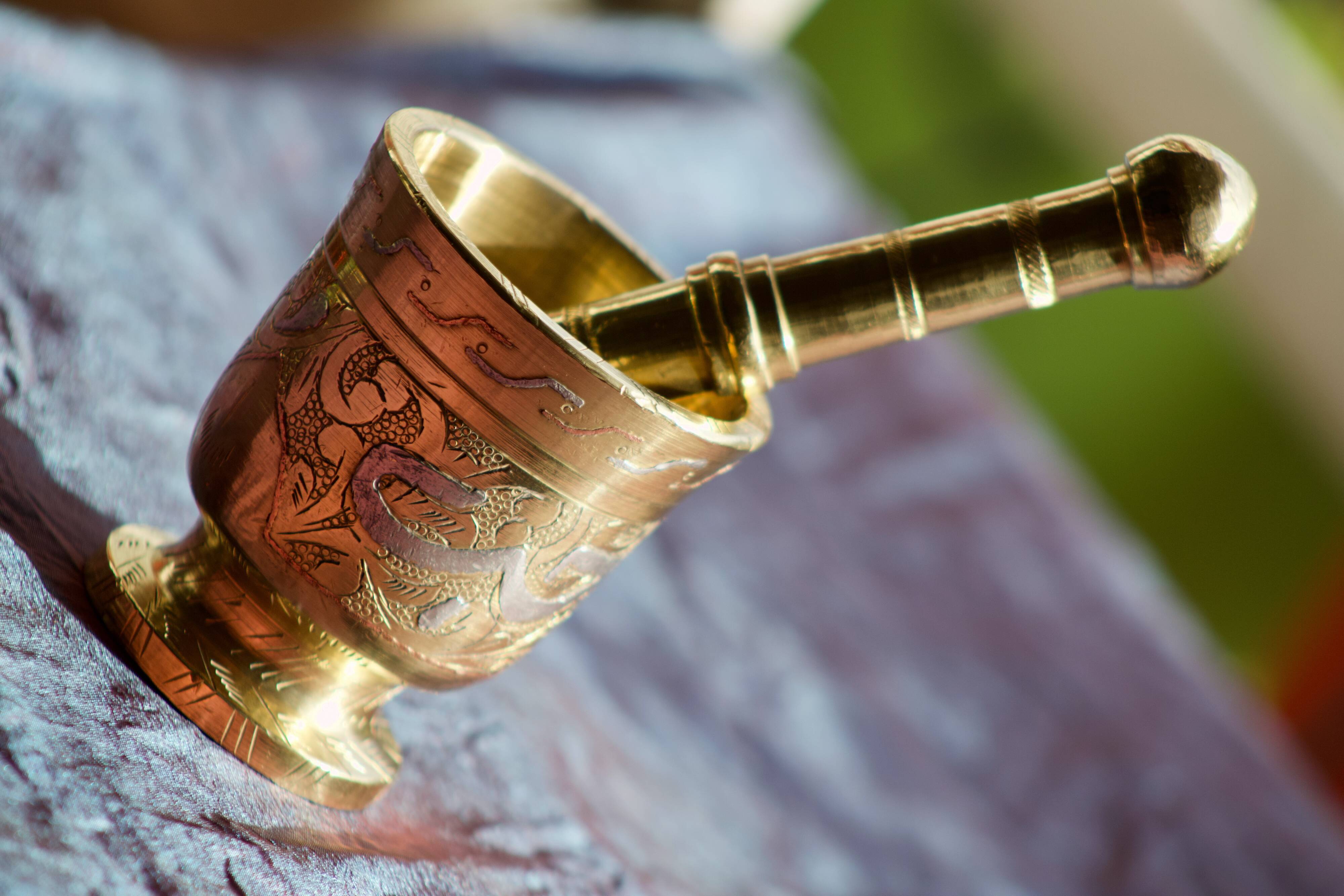 Mortar and its brass pestle with oriental gold and silver motifs