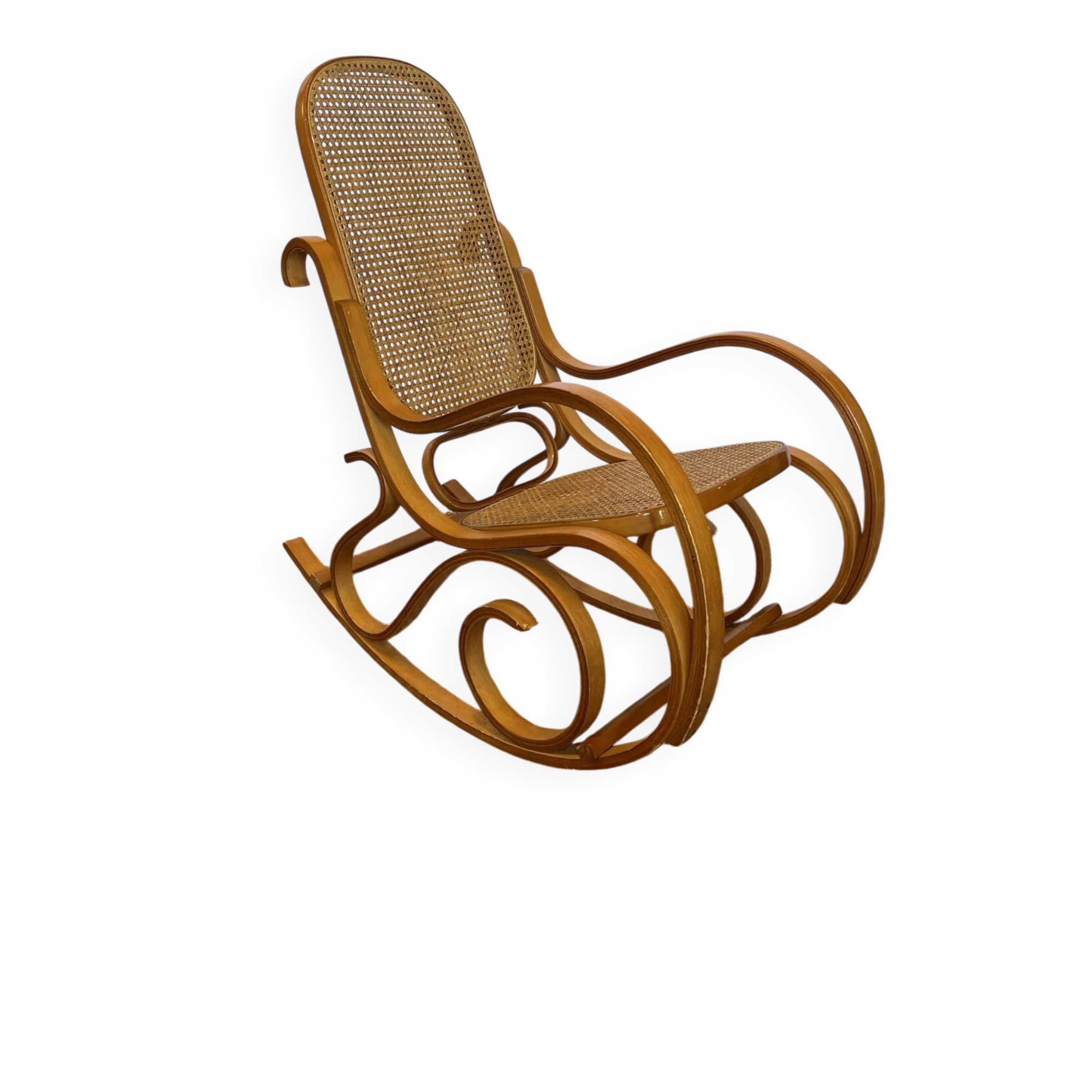 Antique rocking chair in curved wood and caning.