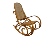 Antique rocking chair in curved wood and caning.