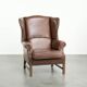 Cowhide wingback armchair in English style finished with decorative nails