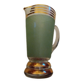 Une carafe verte en verre de la même collection que les 6 verres