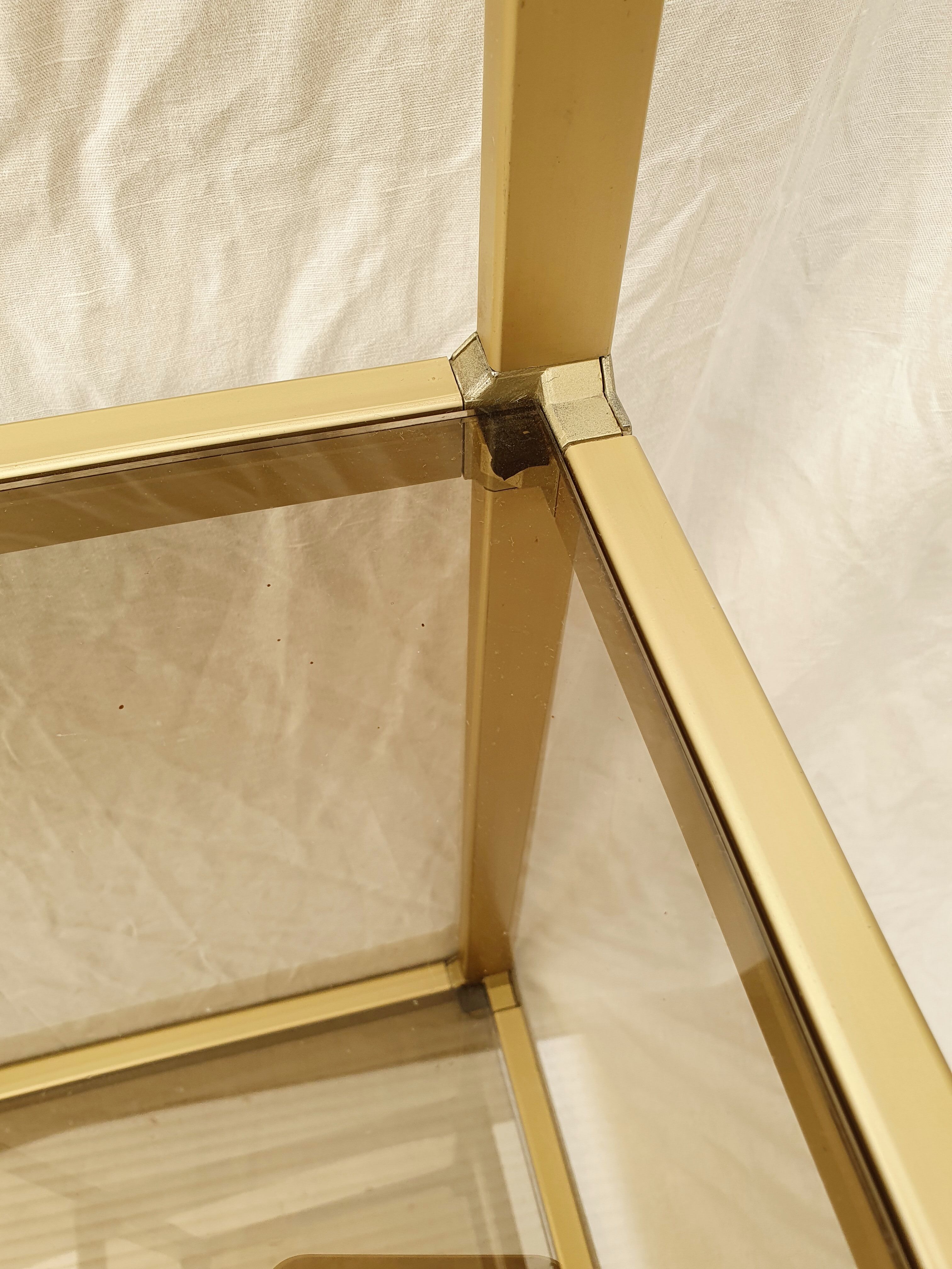Golden metal shelf and smoked glass