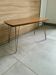 Vintage 1960s coffee table with Formica teak and brass legs.
