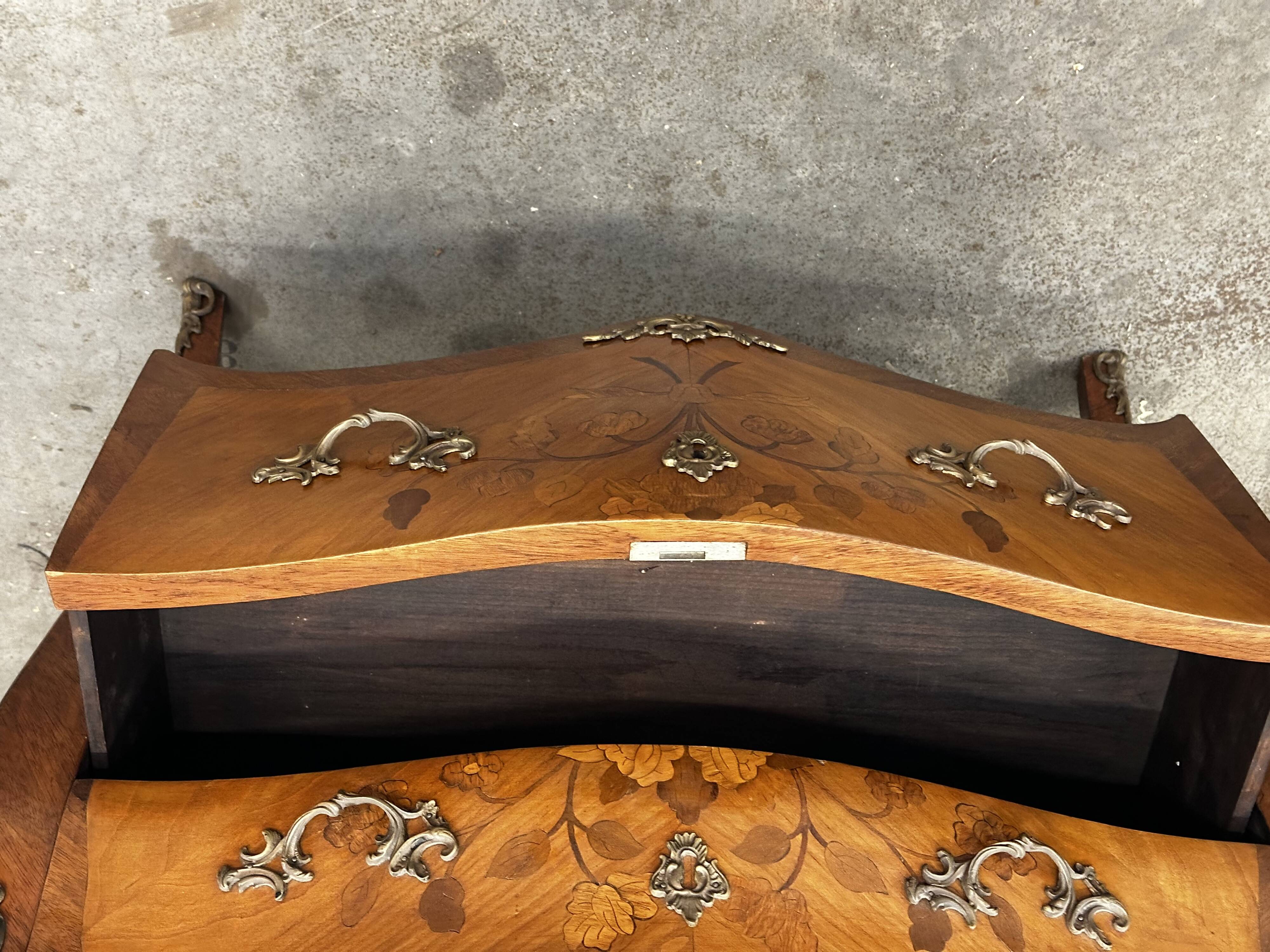 Curved and inlaid Louis XV style chest of drawers