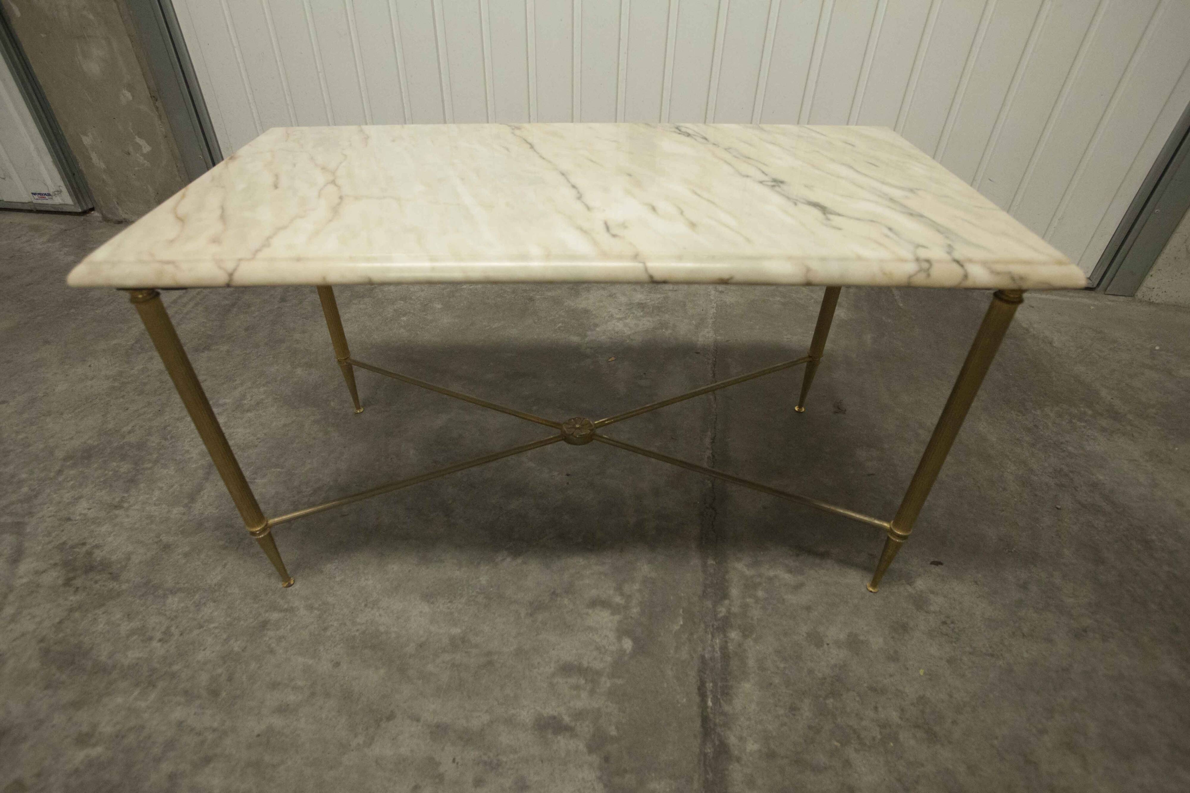 Marble coffee table with brass legs, height 46 cm.