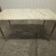 Marble coffee table with brass legs, height 46 cm.