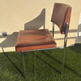 A pair of vintage brown Skaï chairs.