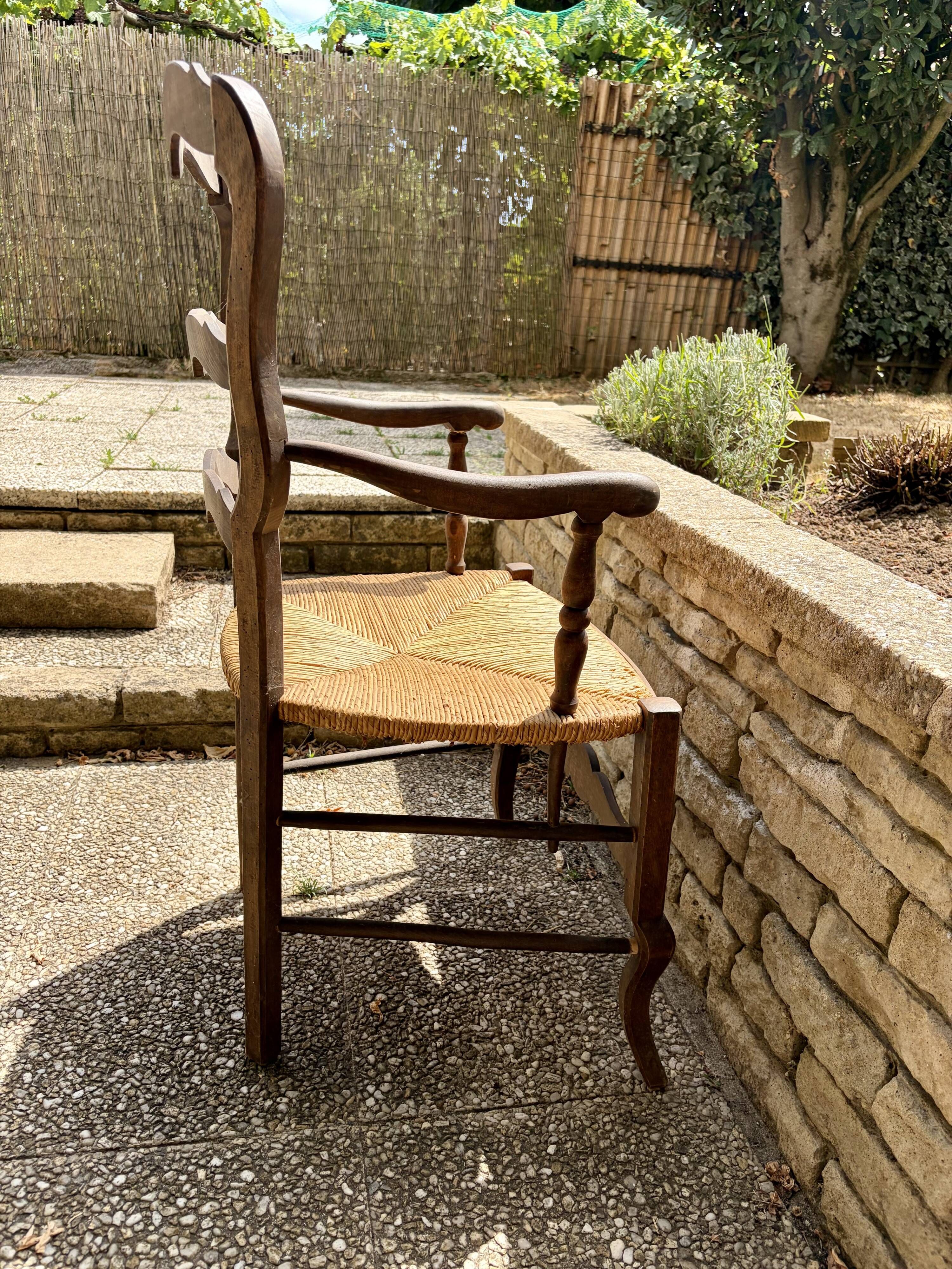 Antique Provençal armchair in wood with a straw seat.