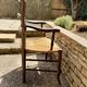 Antique Provençal armchair in wood with a straw seat.
